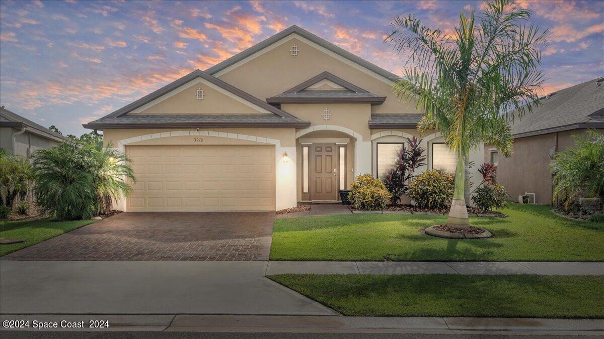 a front view of a house with a yard and garage