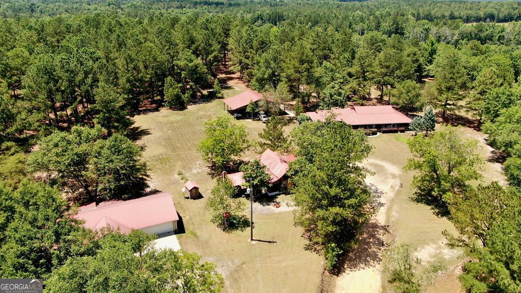 an aerial view of residential house with yard and swimming pool