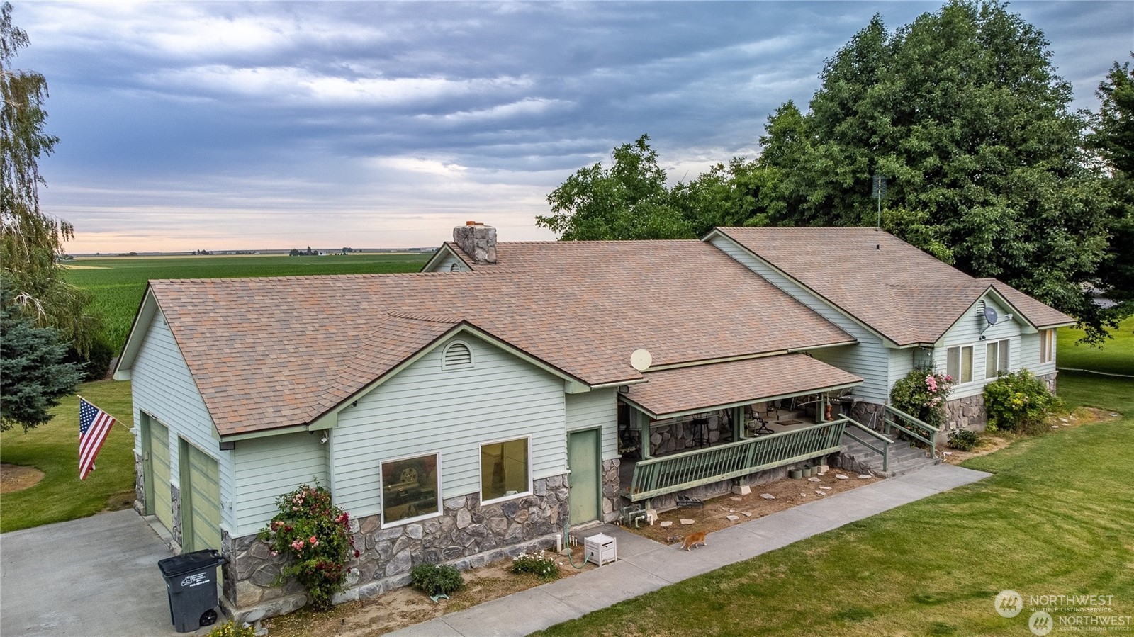 a aerial view of a house next to a yard