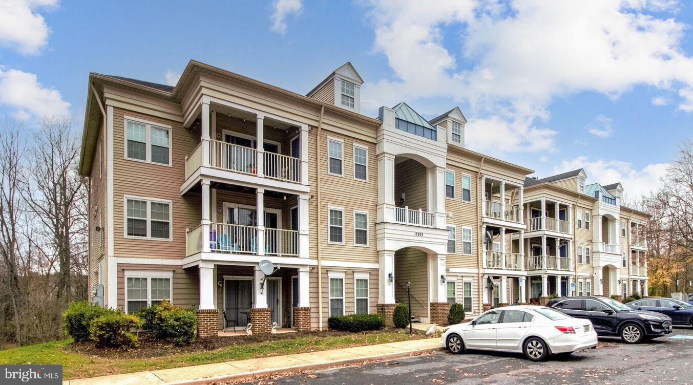 a front view of a residential apartment building with a yard