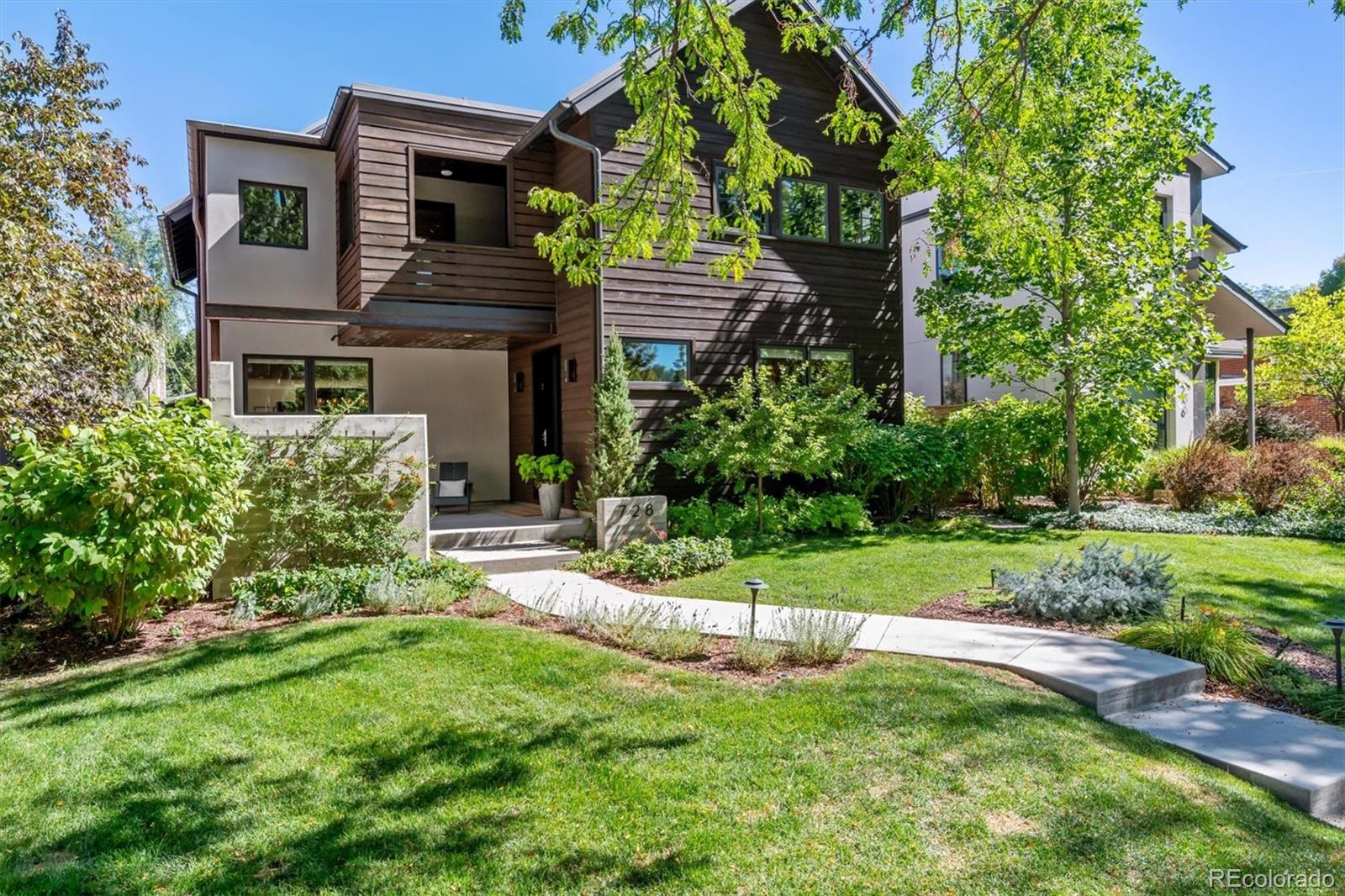 a view of a house with a yard and plants