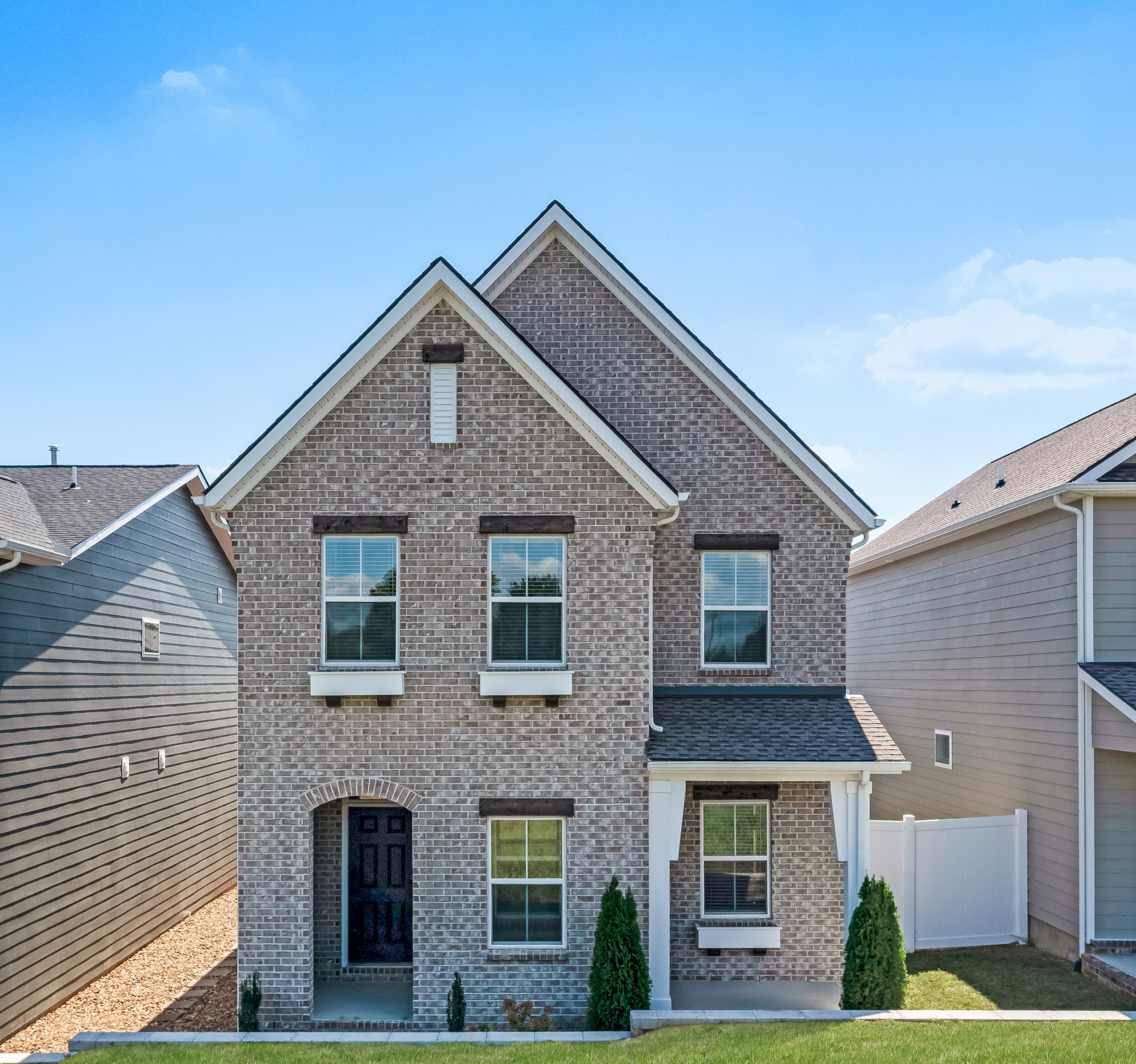 The Victoria plan with Tudor style elevation. This plan is a 3 bedroom home with primary on main. beautiful covered front porch.