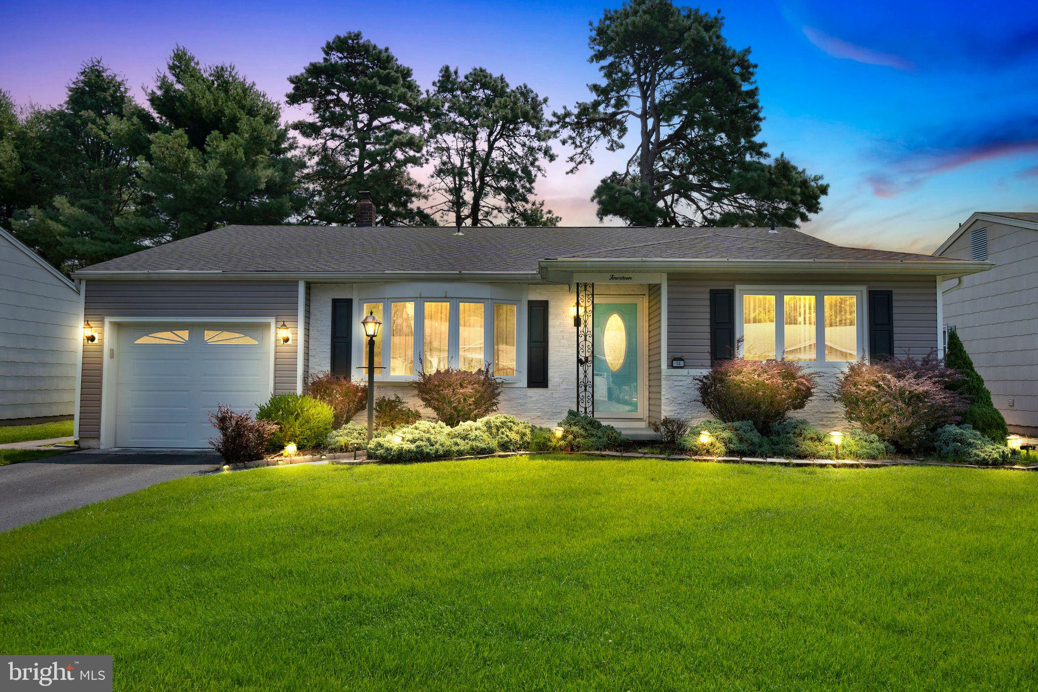 a front view of a house with yard and outdoor seating