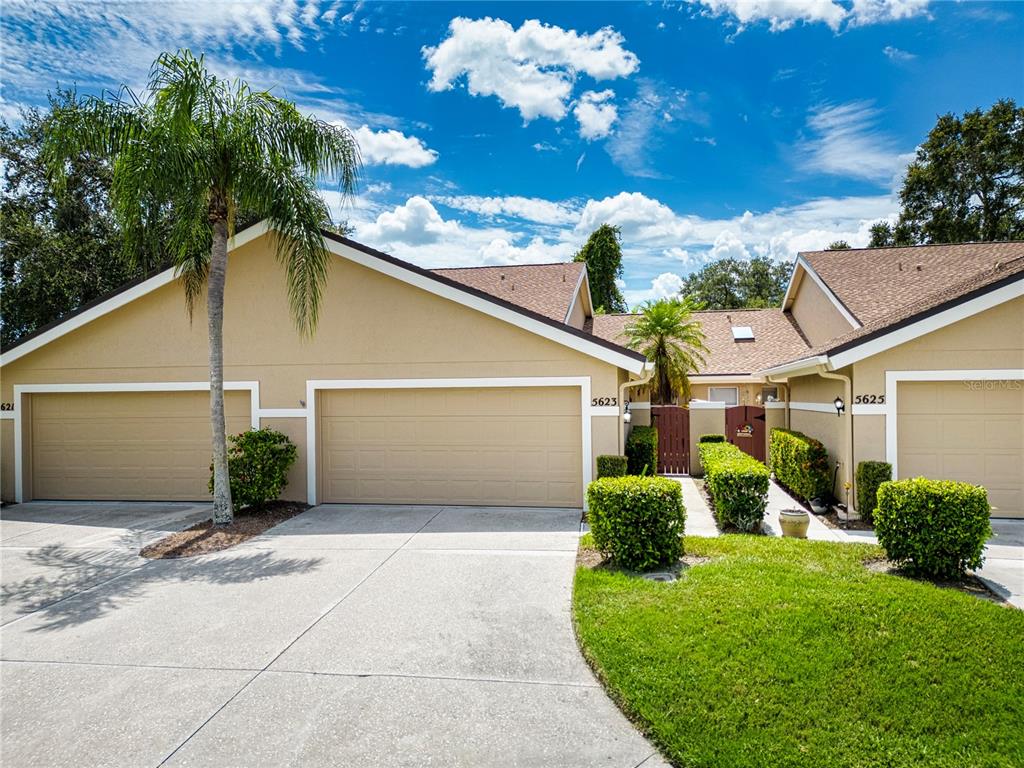 a view of a house with backyard and a garage