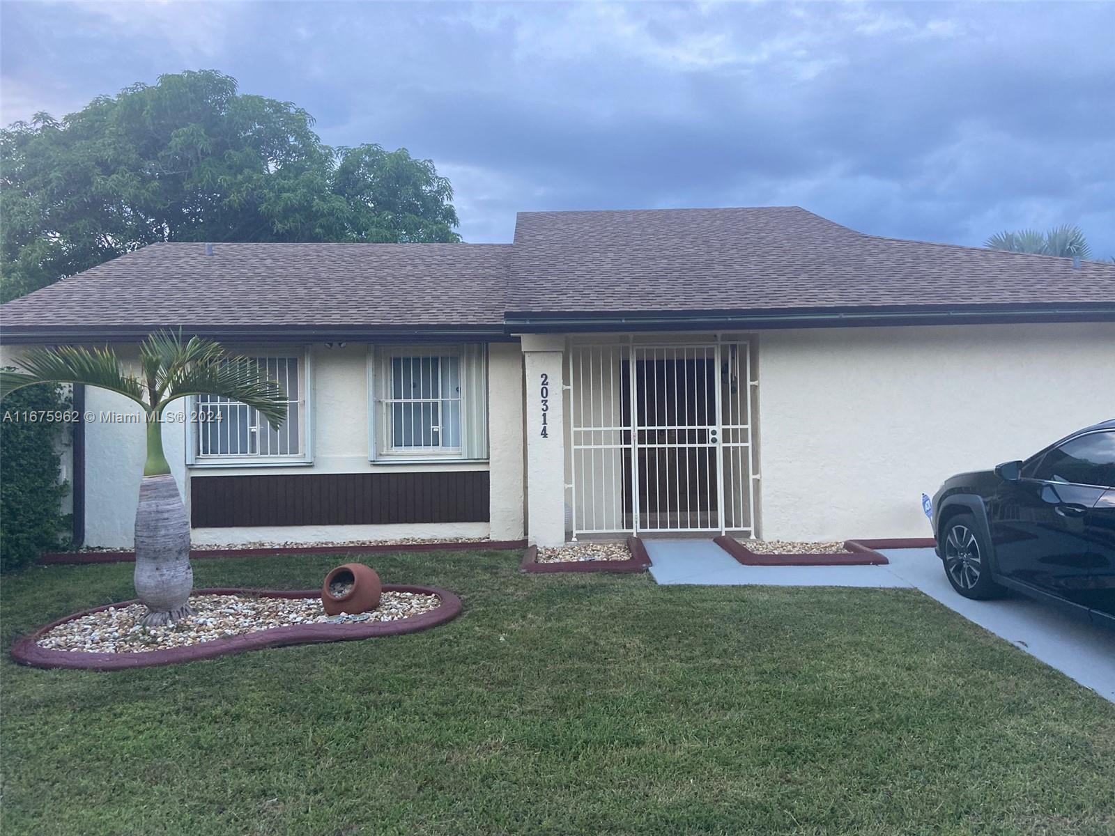 a front view of a house with a garden