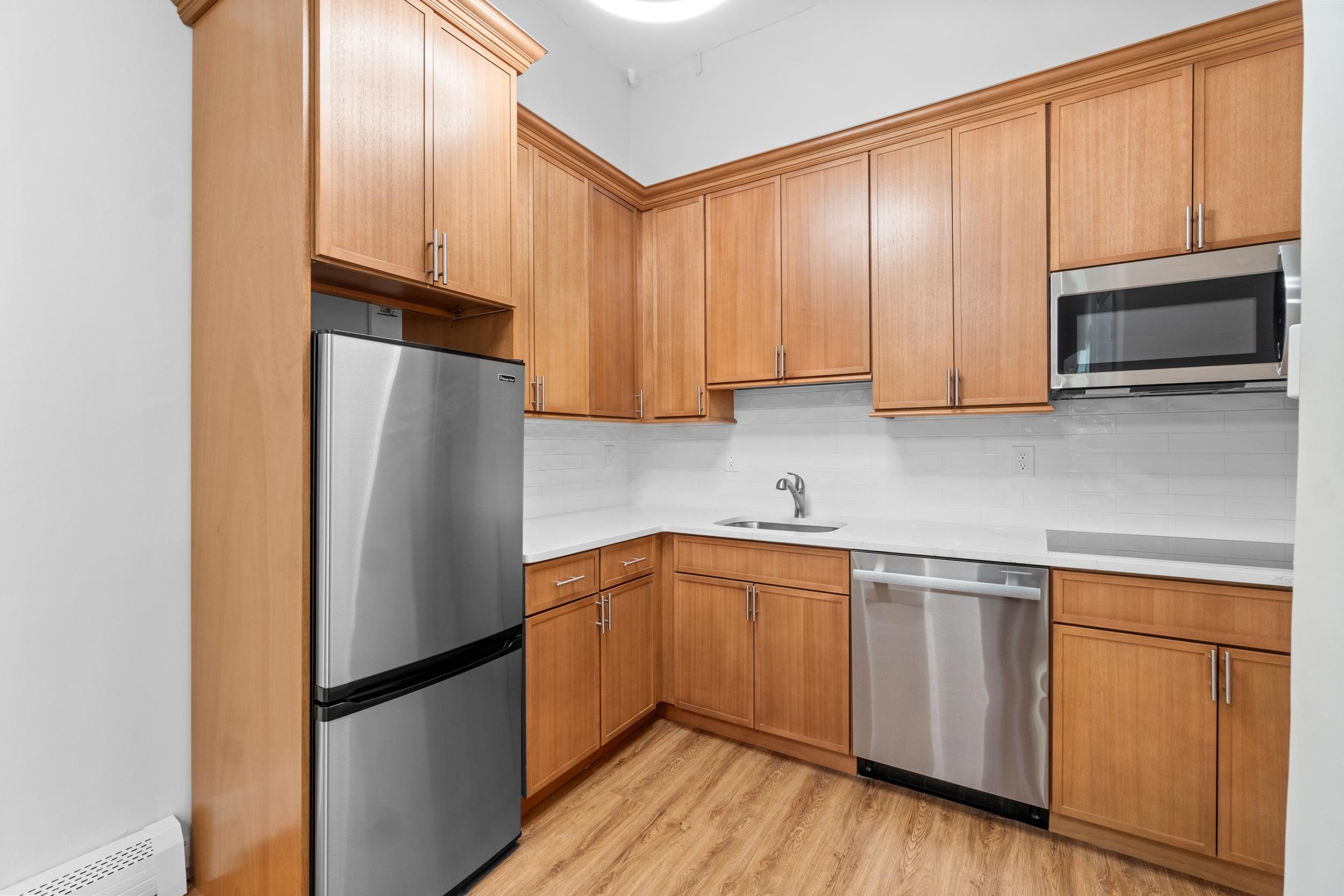 a kitchen with a refrigerator sink and microwave