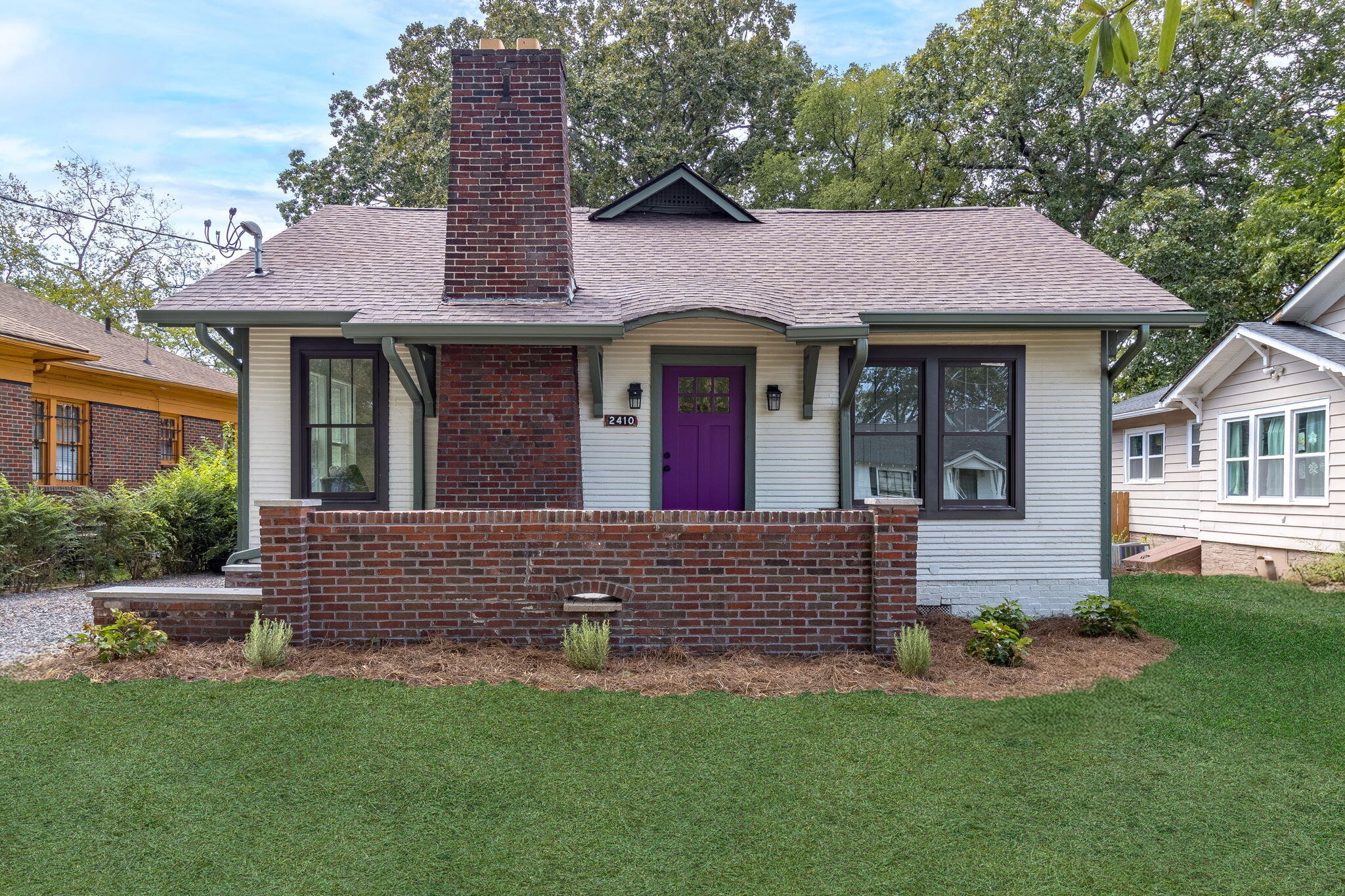 a front view of a house with a garden