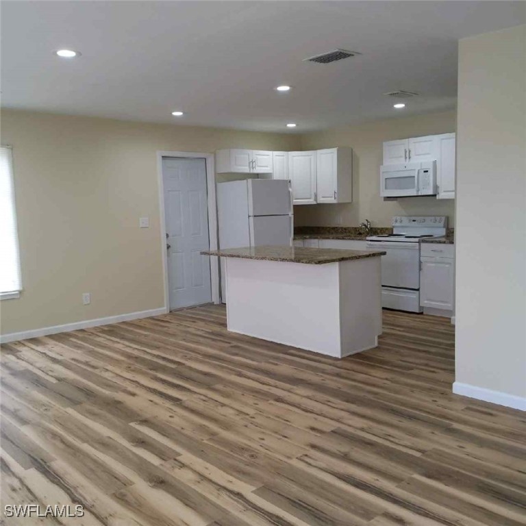 a kitchen with stainless steel appliances granite countertop a stove and a sink