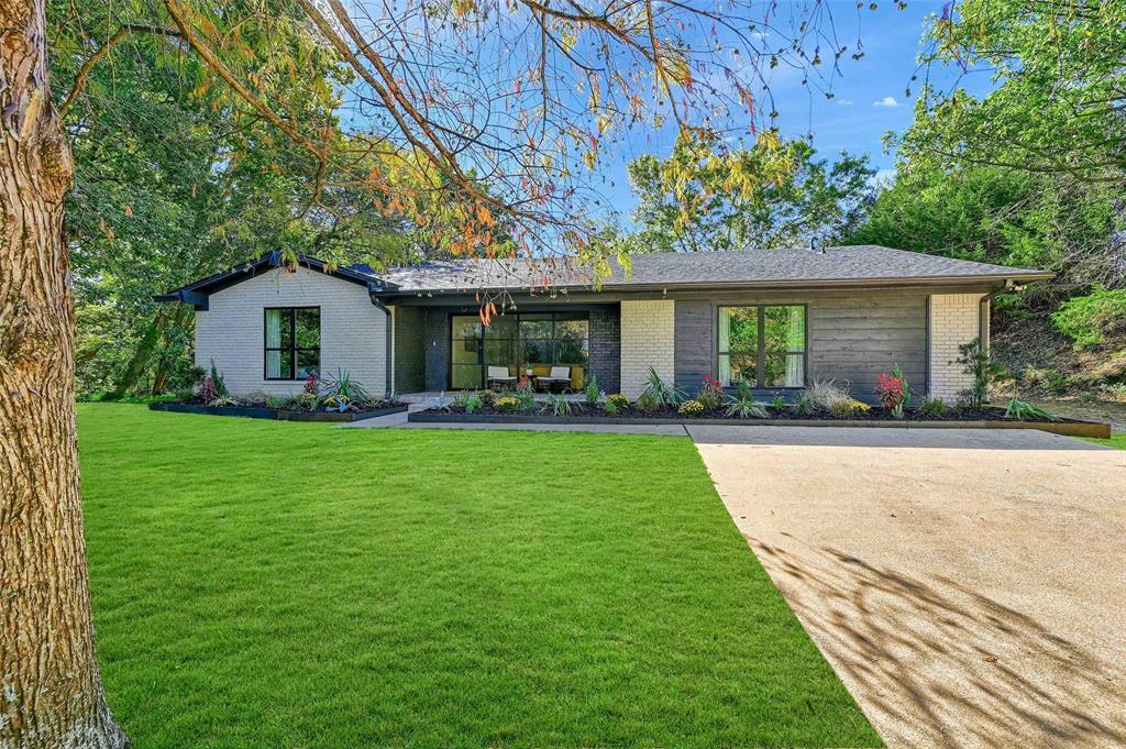 a front view of house with yard and green space