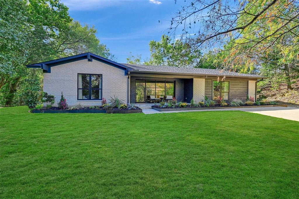 a front view of house with yard and outdoor seating