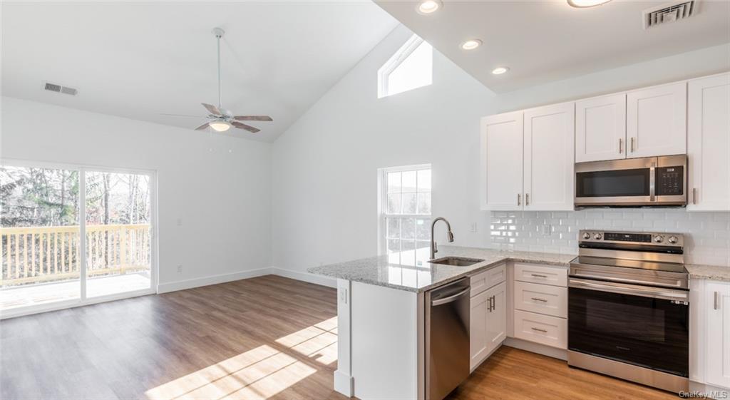 a kitchen with a sink stove and microwave