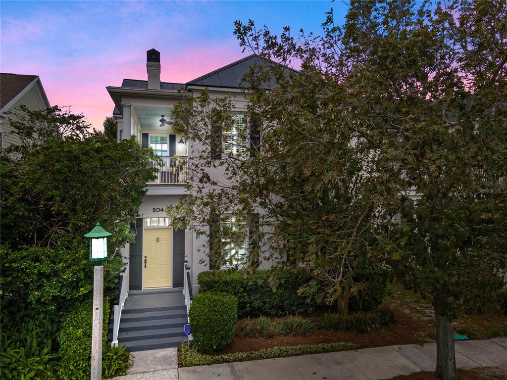 a front view of a house with trees