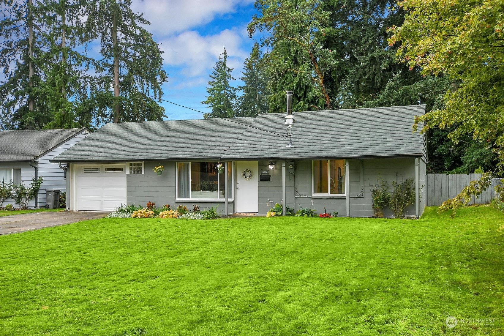 a front view of a house with a yard and trees