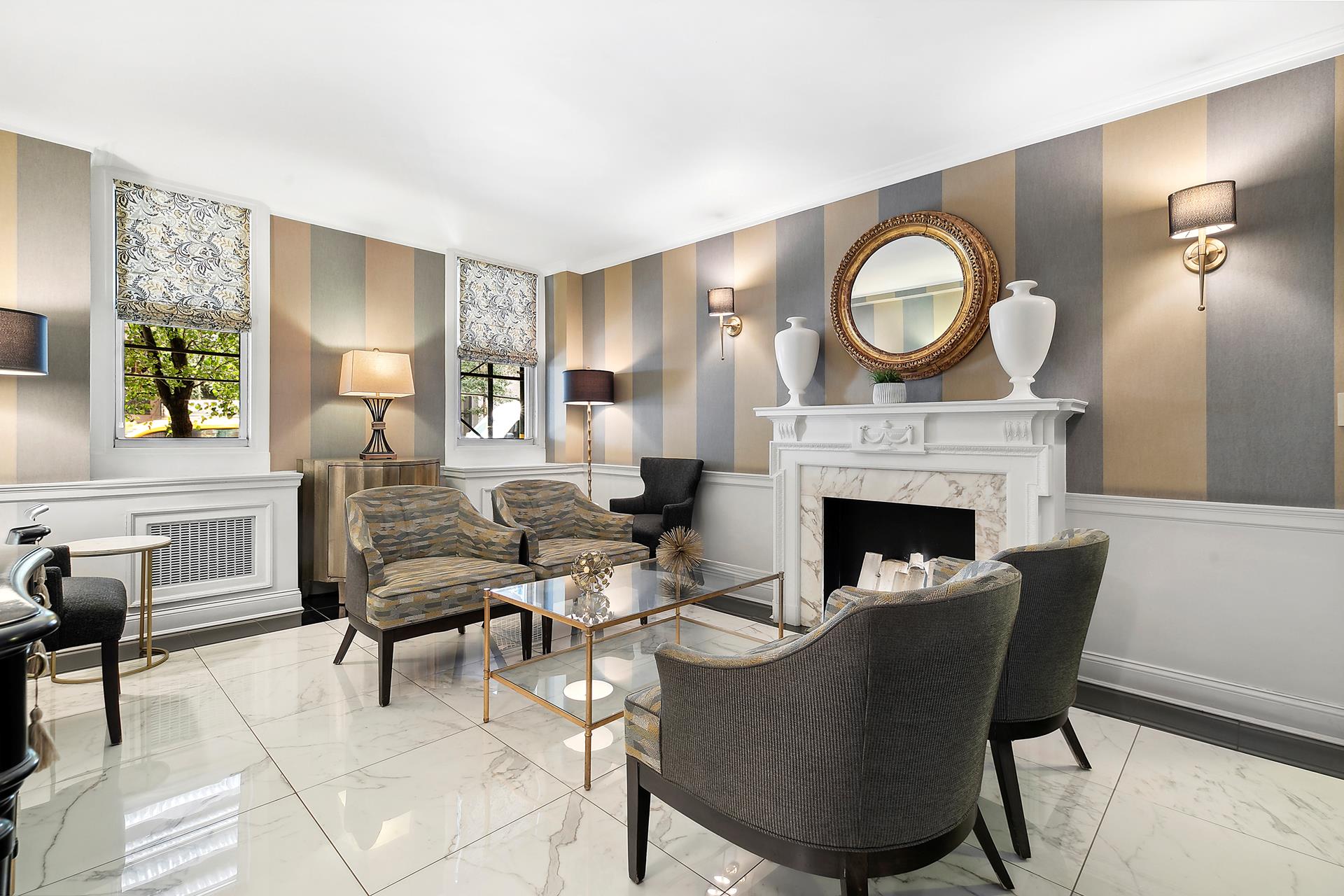 a living room with furniture a fireplace and a potted plant