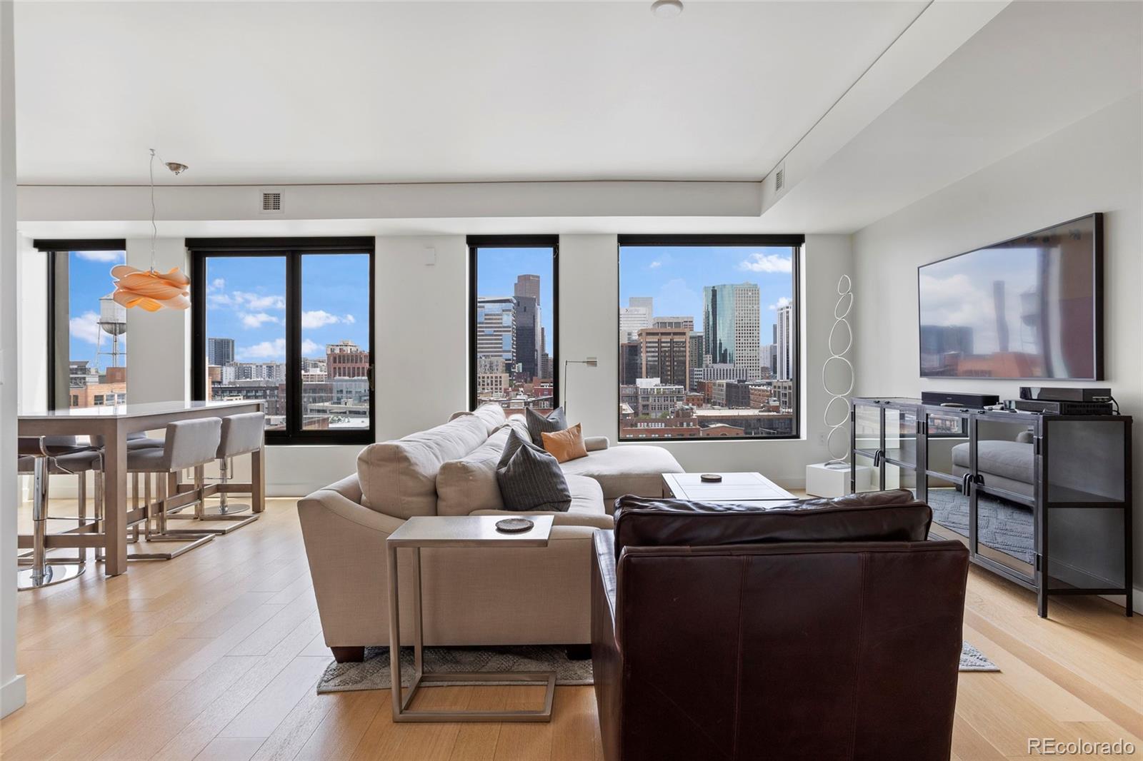 a living room with furniture and large windows