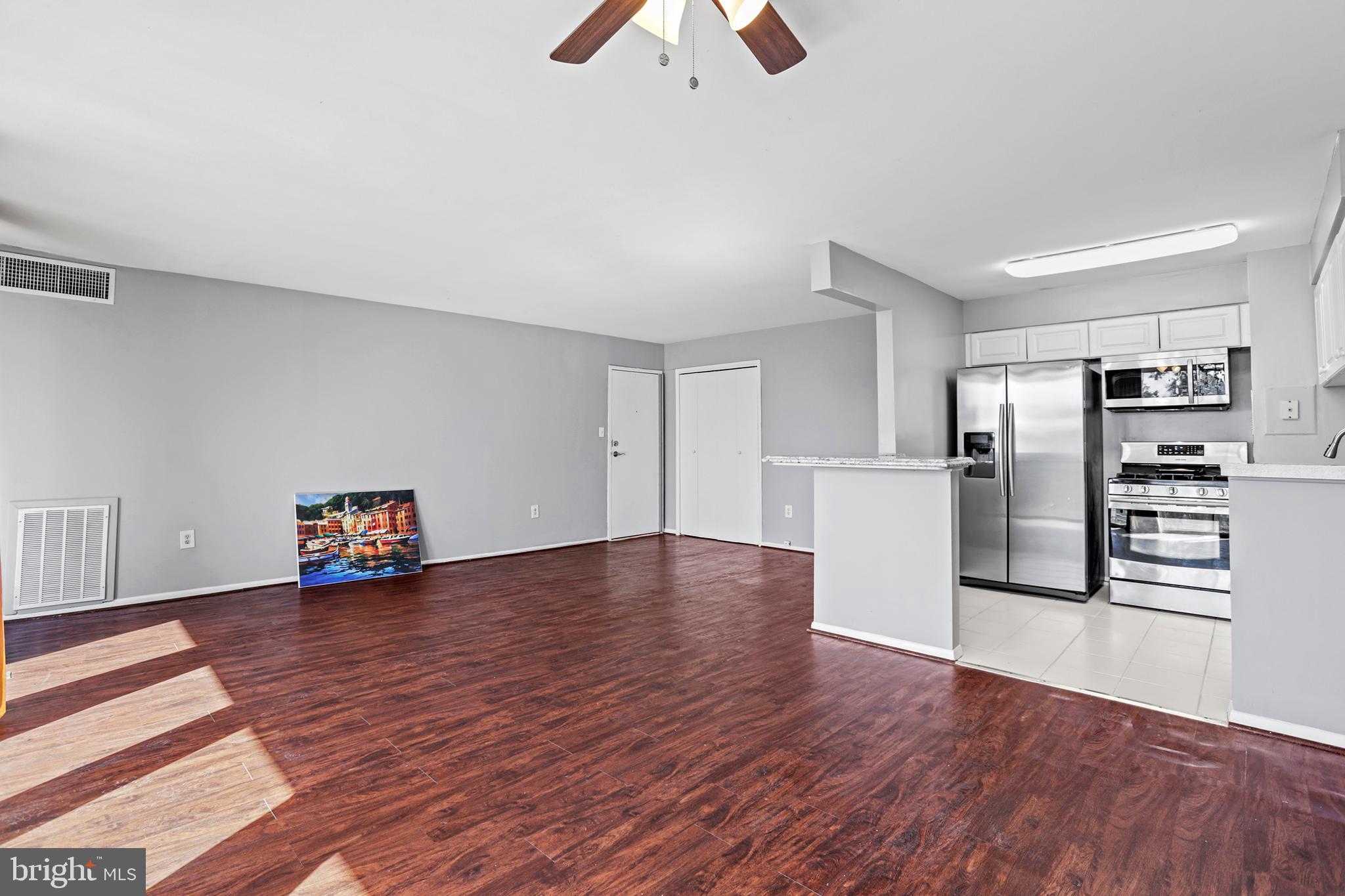 a view of empty room with wooden floor