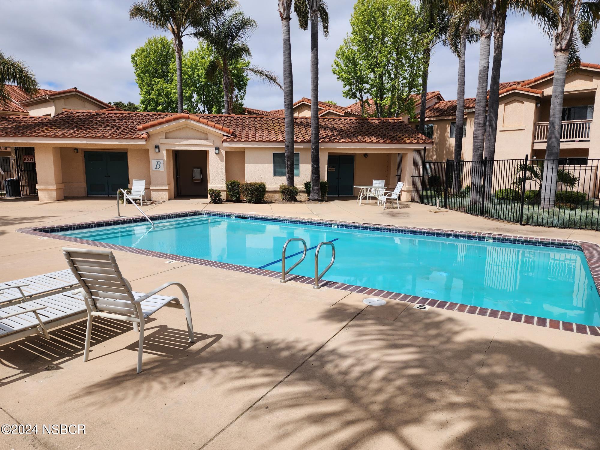 a view of a swimming pool with a lounge chairs