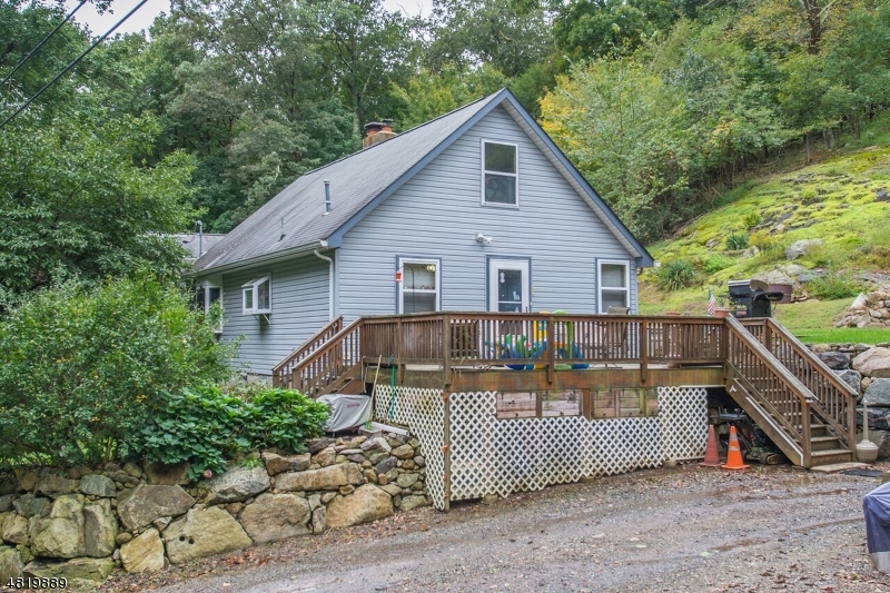 a view of a house with a yard and deck