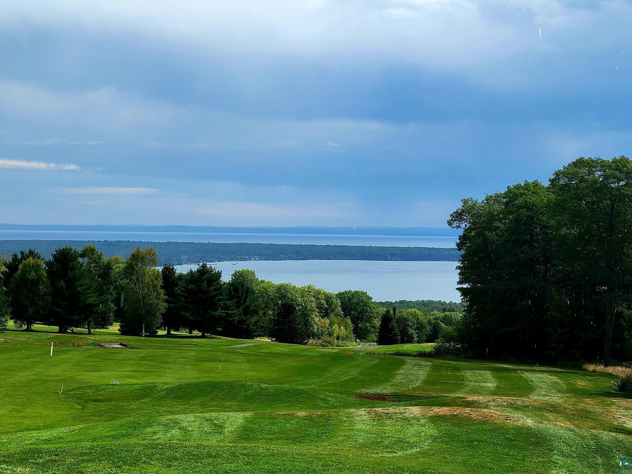 View of community with a lawn and a water view