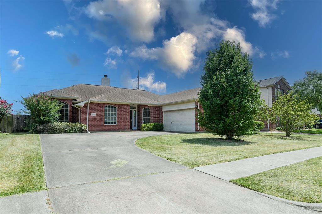 a front view of a house with a yard and trees