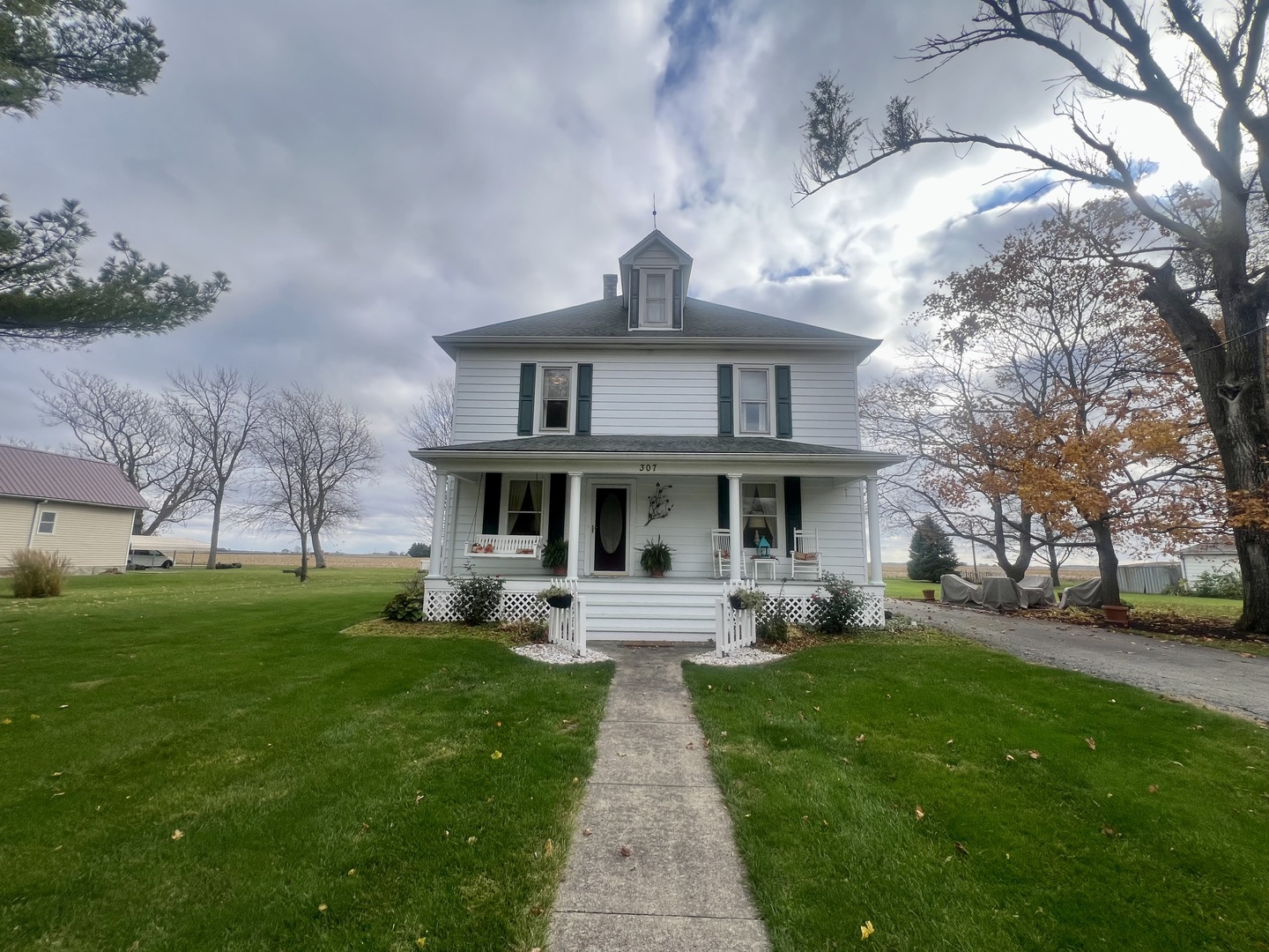 a front view of house with yard and green space