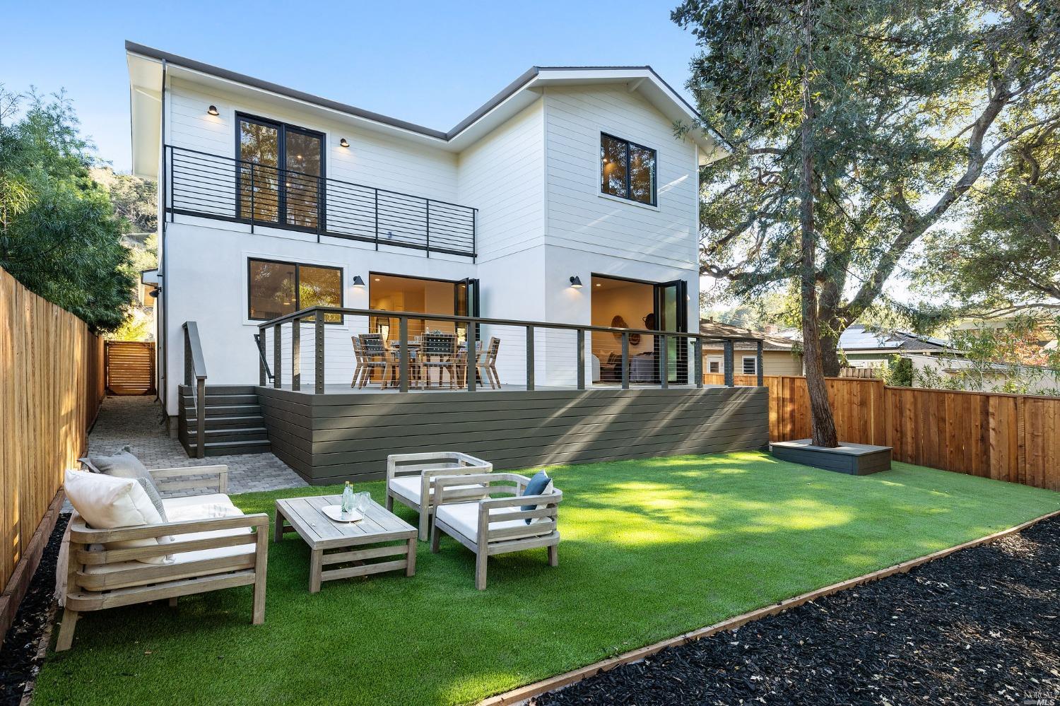 a view of a house with backyard sitting area and garden