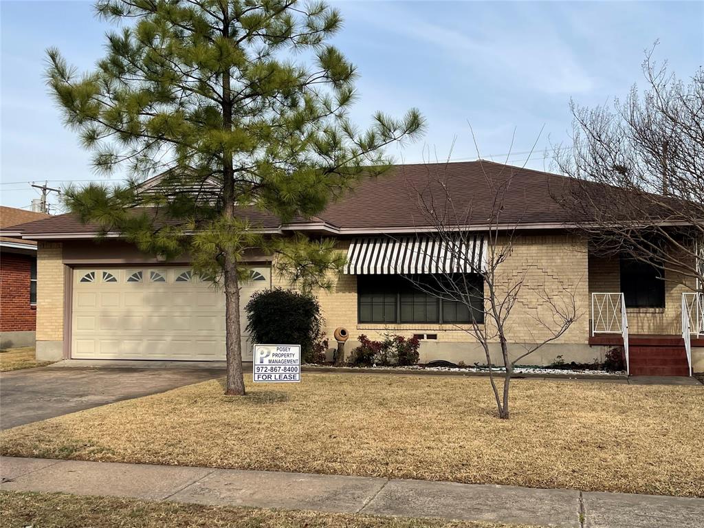 View of front of home featuring a garage and a front lawn