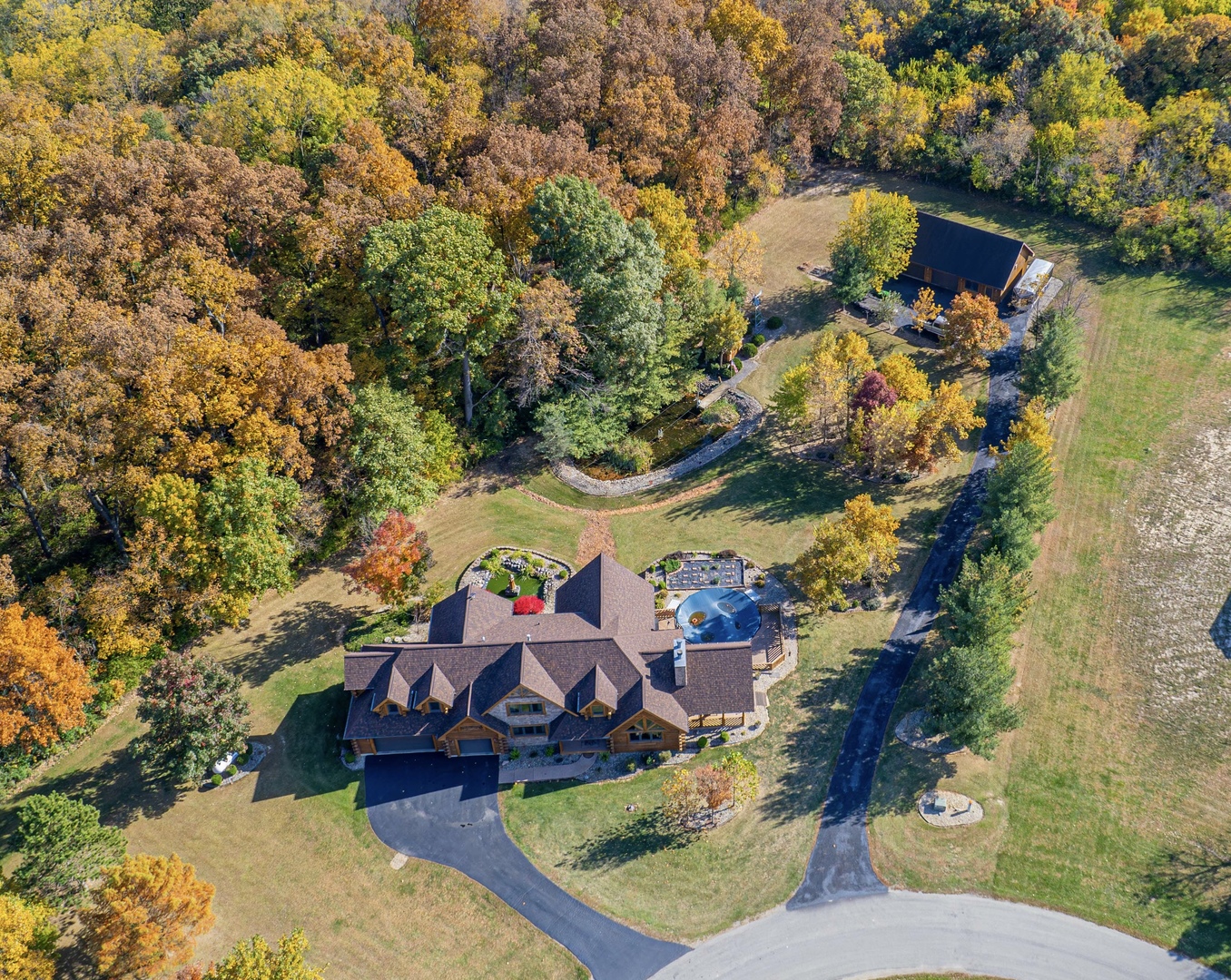 an aerial view of a house with a yard and lake view