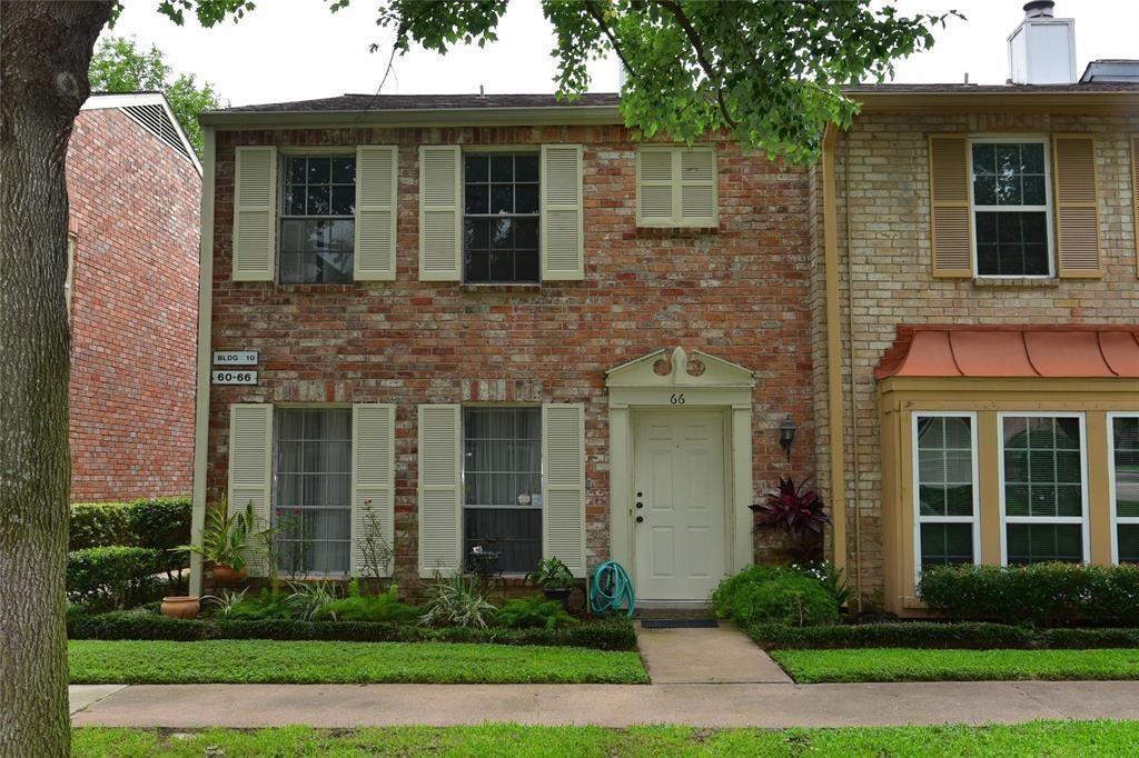 a front view of a house with a yard and porch