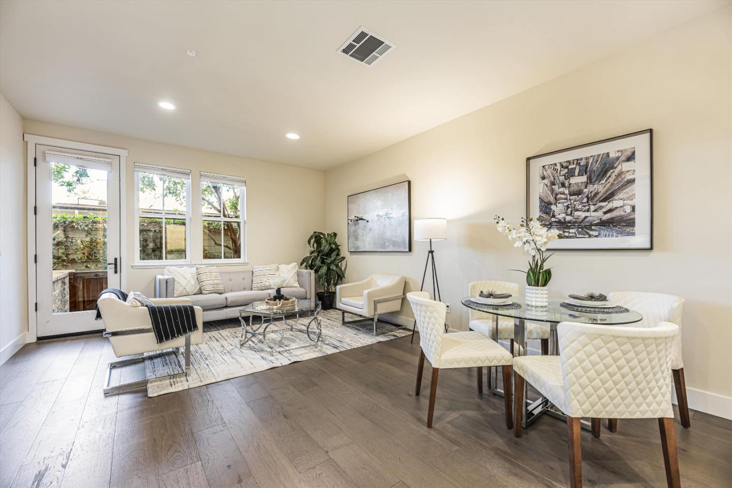 a living room with furniture and wooden floor