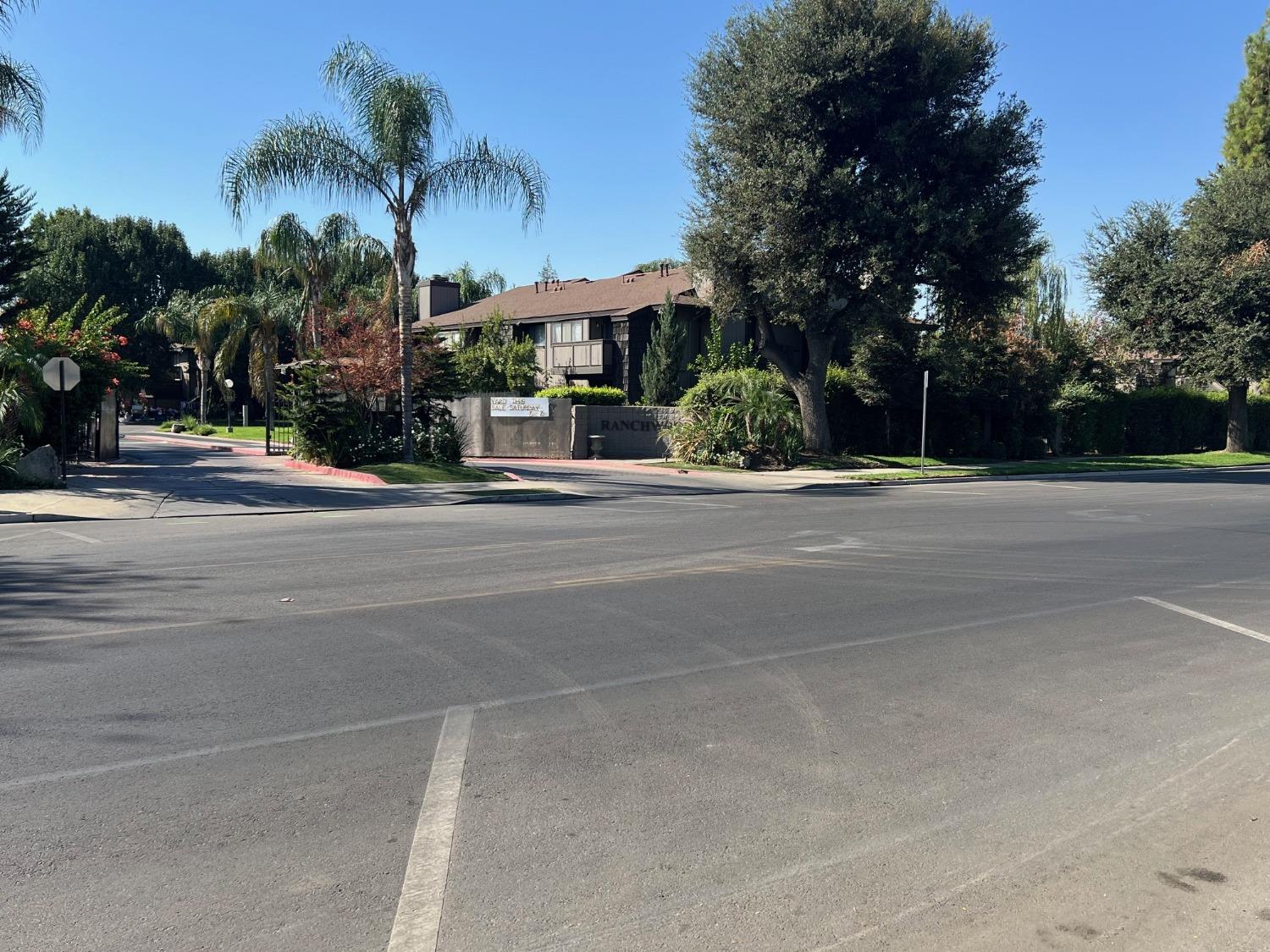 a front view of a house with palm trees