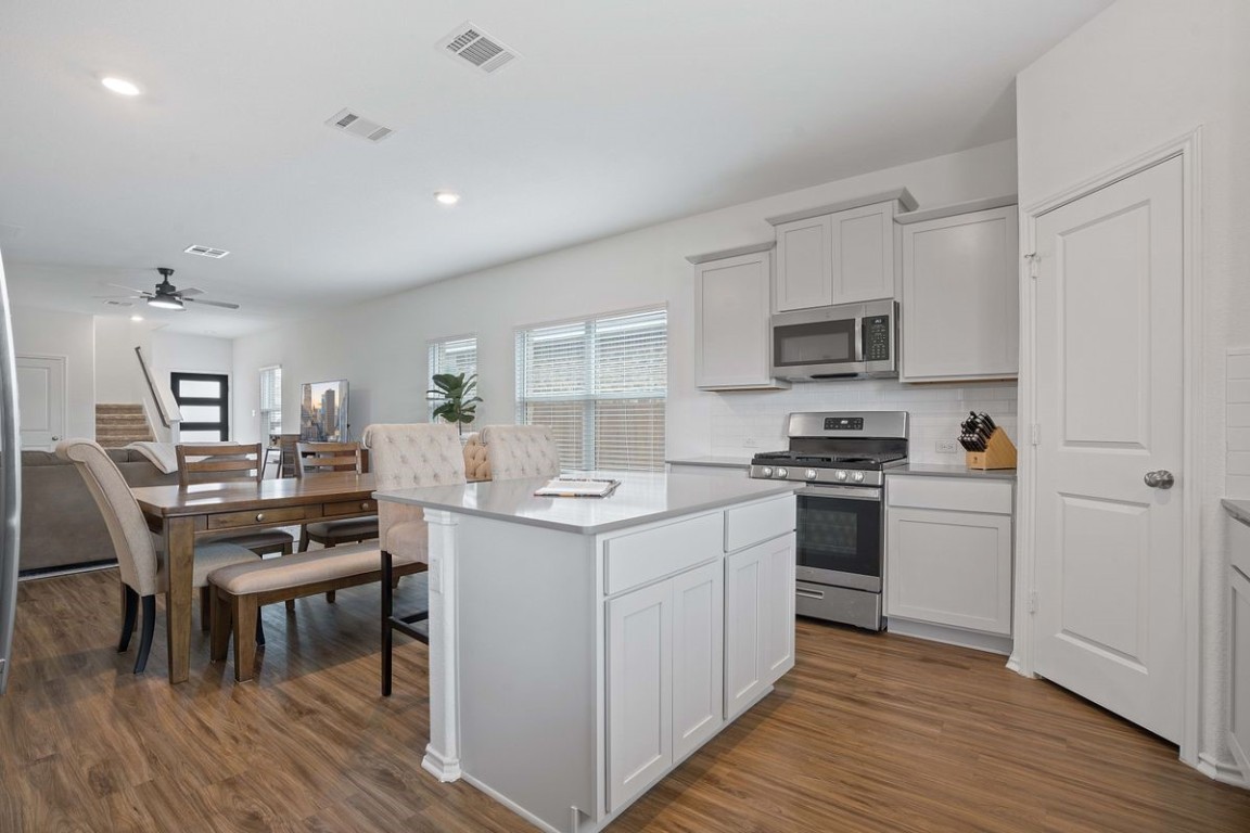 a kitchen with a sink appliances and cabinets