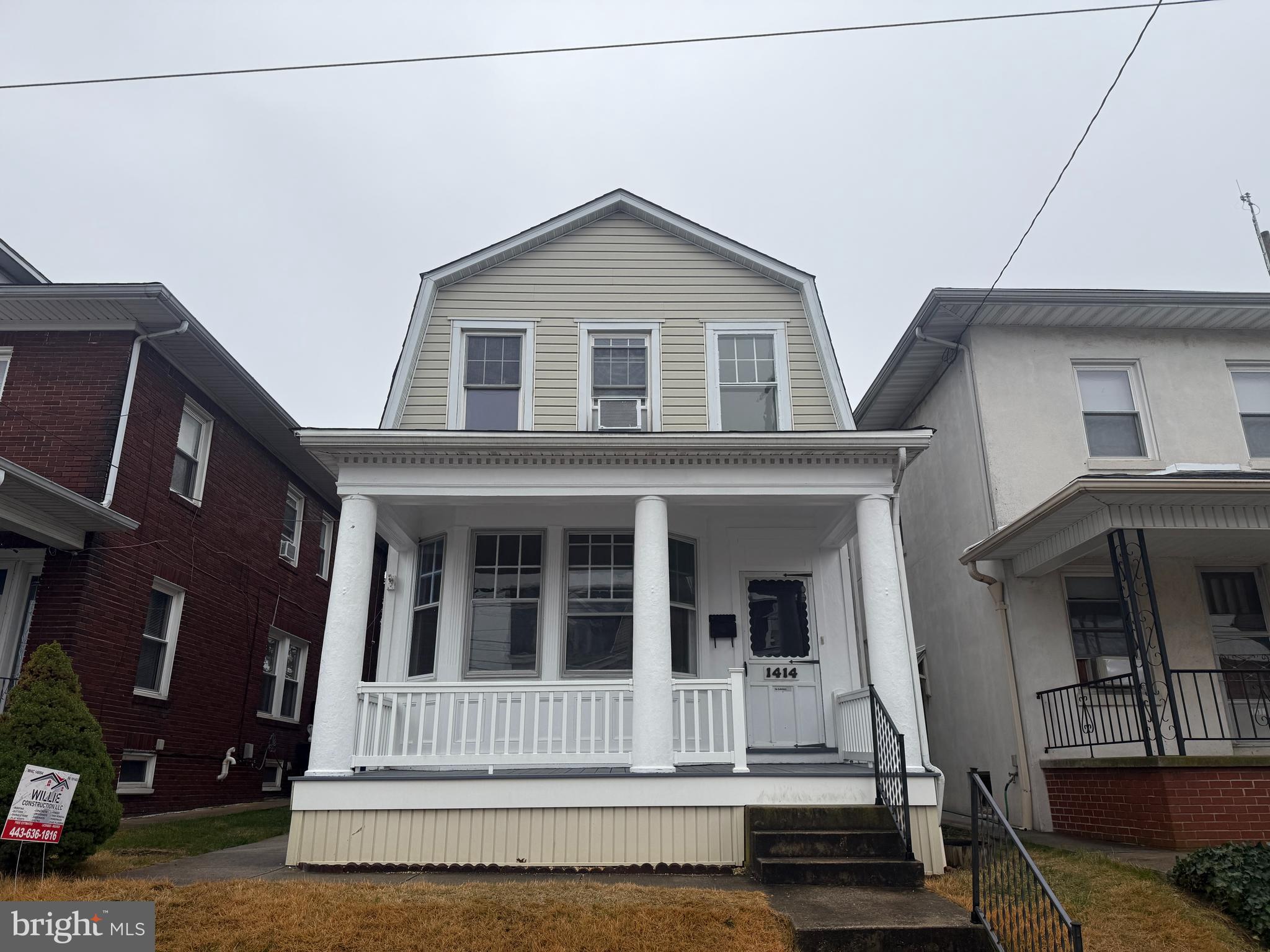 a front view of a house with a small yard