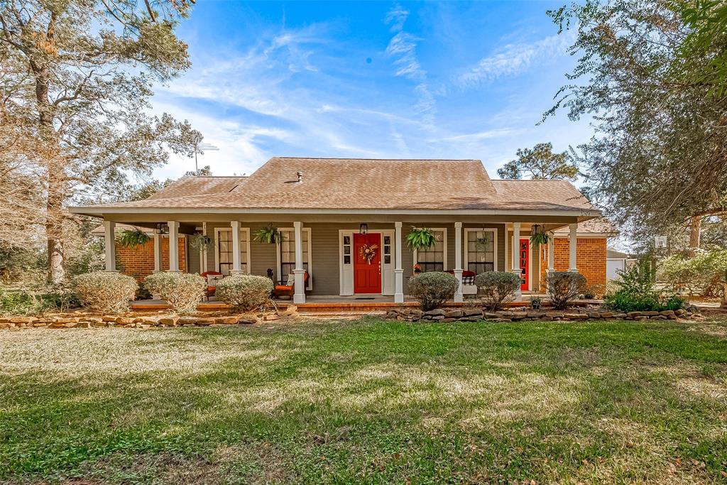 a front view of a house with a garden and patio