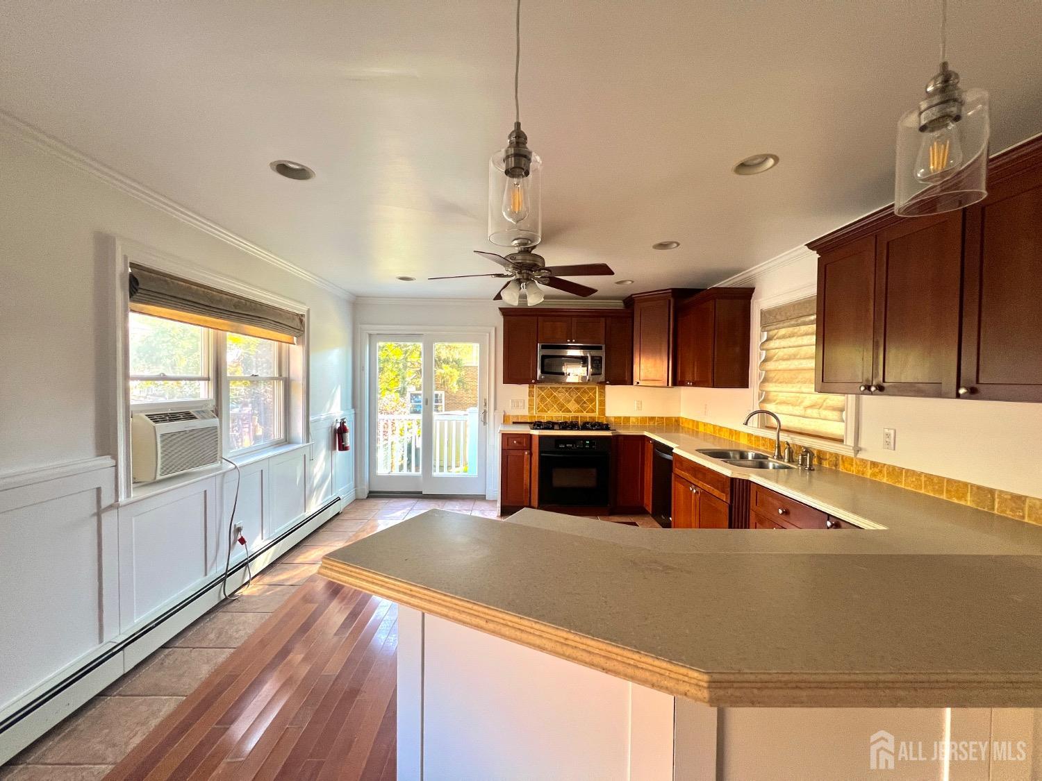 a kitchen with stainless steel appliances granite countertop a sink a stove and a refrigerator