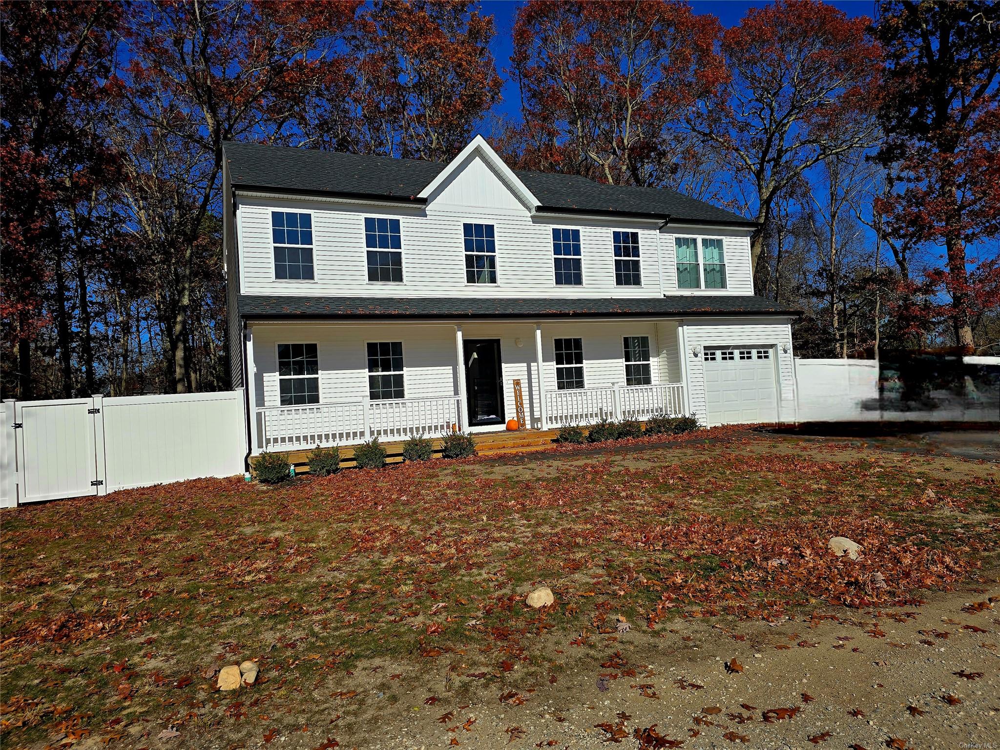 View of front of property with covered porch and a garage