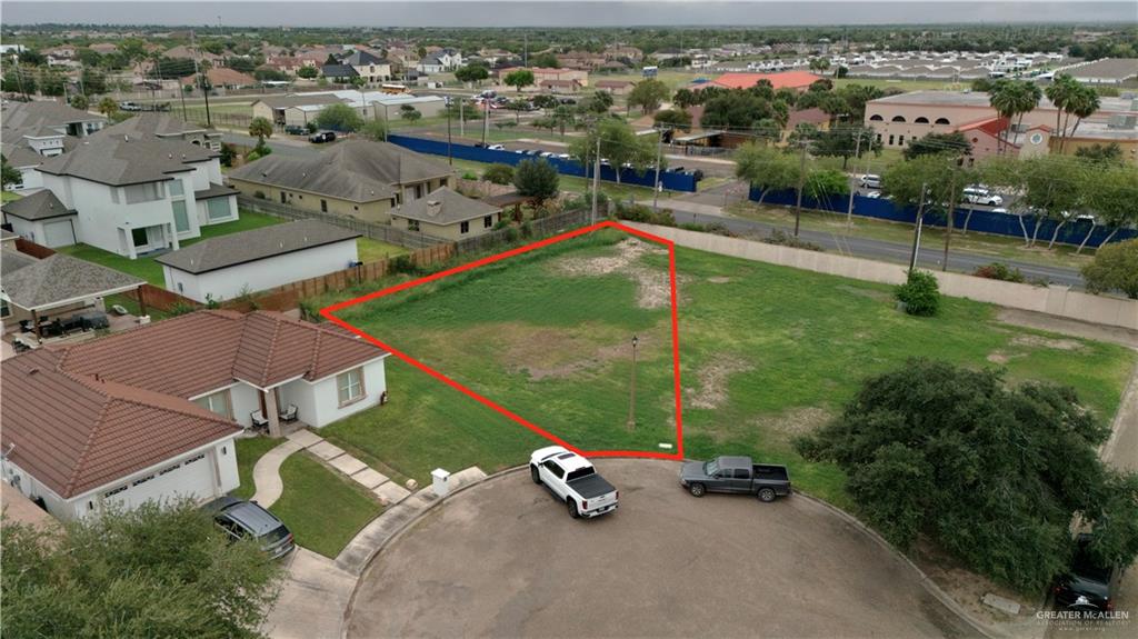 an aerial view of a house with a yard and lake view