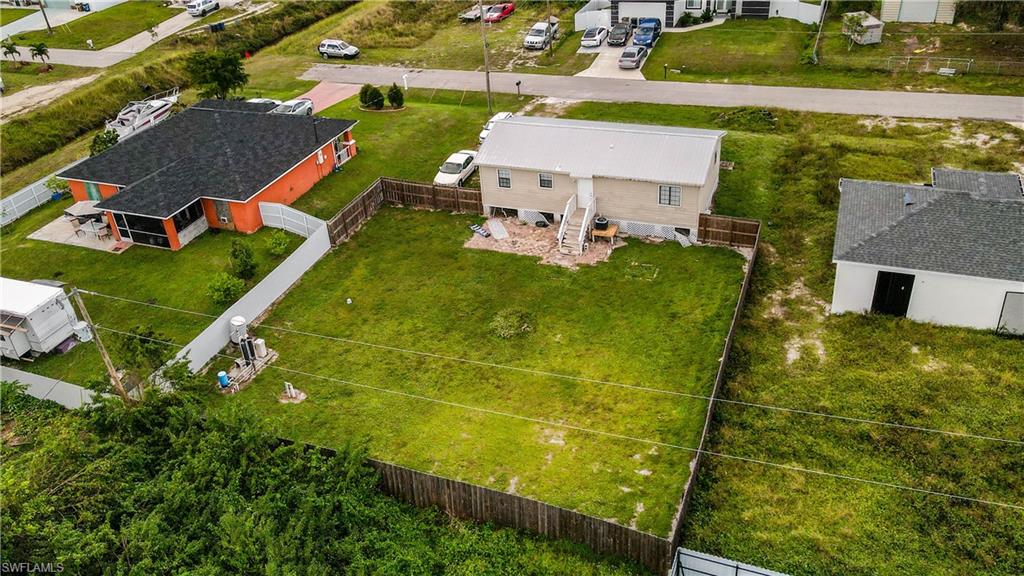 an aerial view of a house with pool yard and outdoor seating