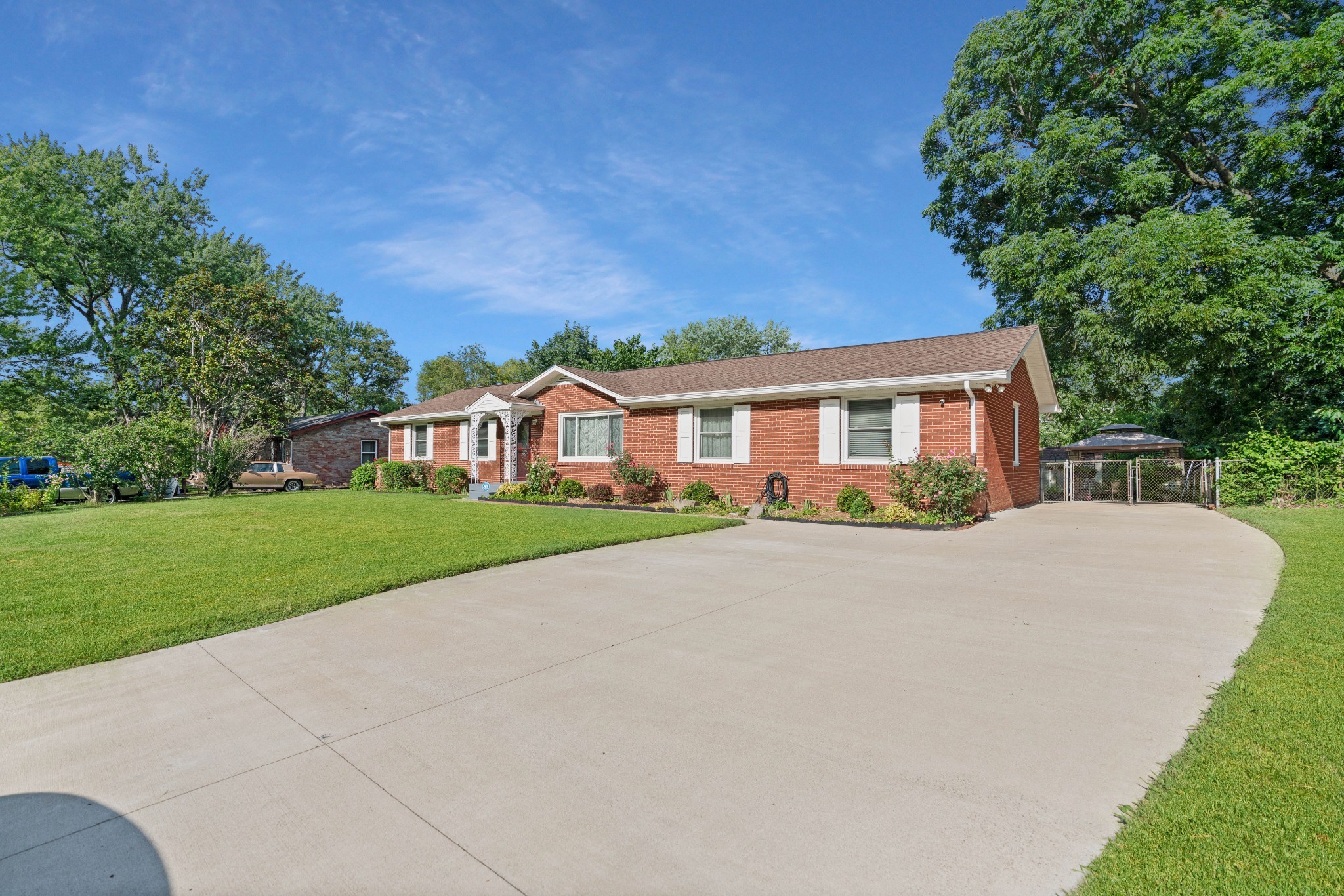 a front view of house with yard and green space