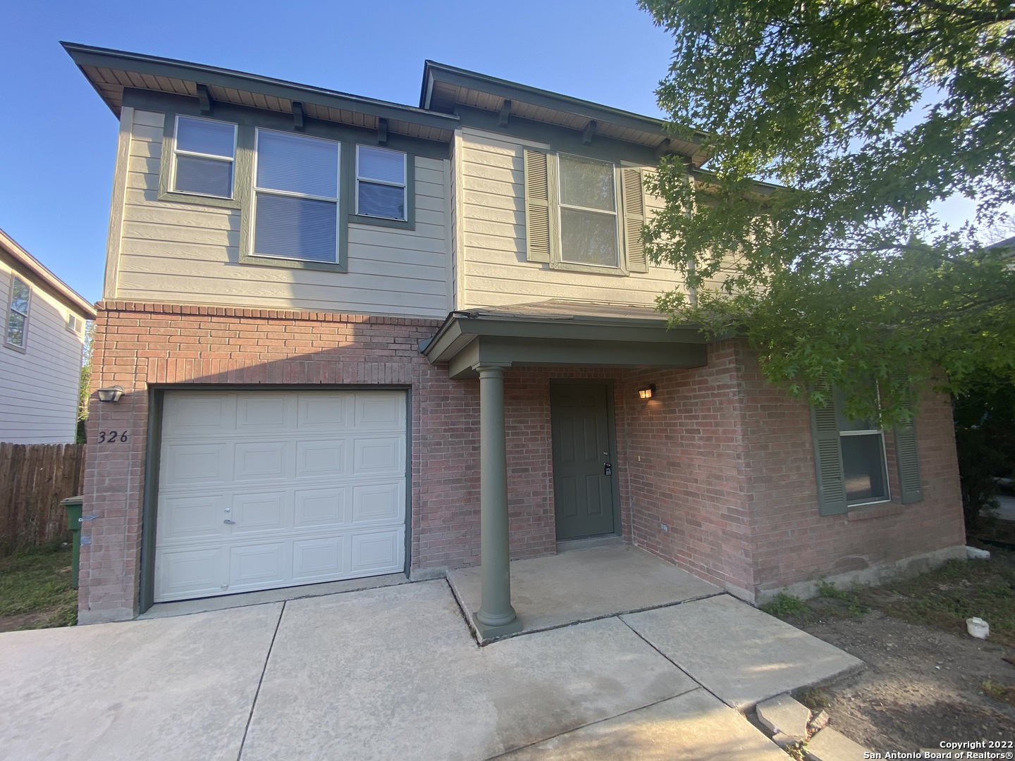 a front view of a house with garage