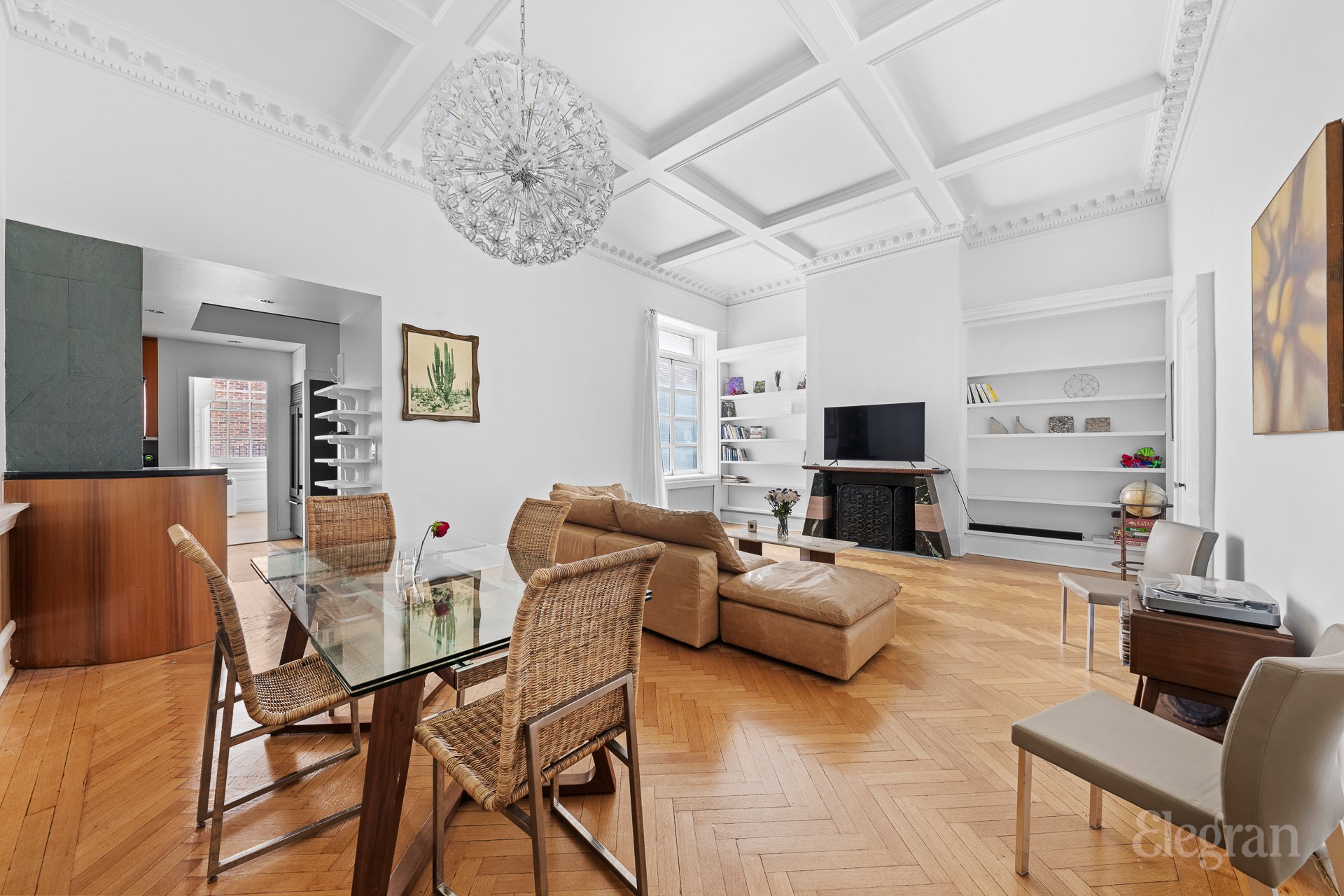 a living room with furniture a flat screen tv and a large window