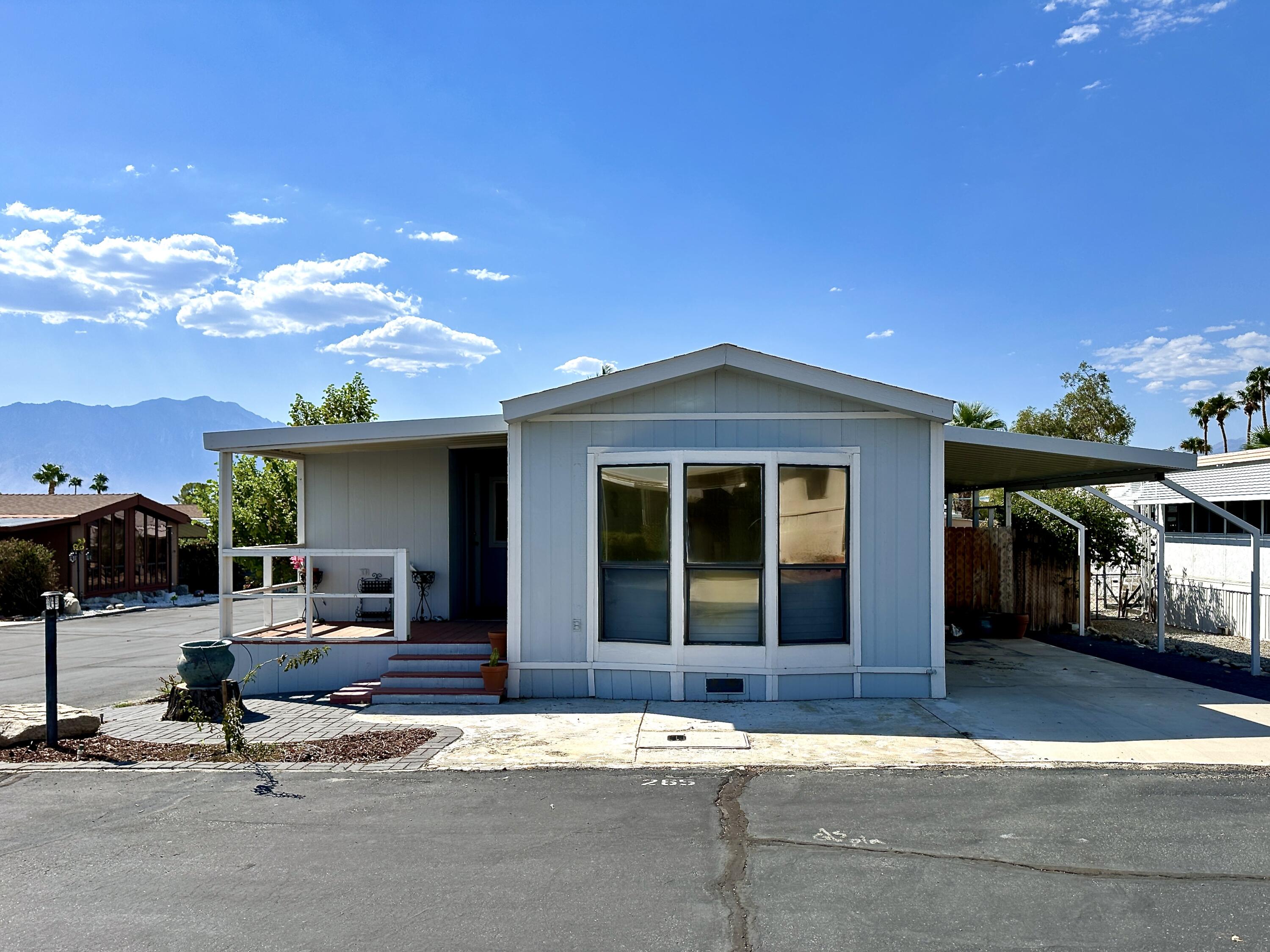 a view of a house with outdoor space and parking