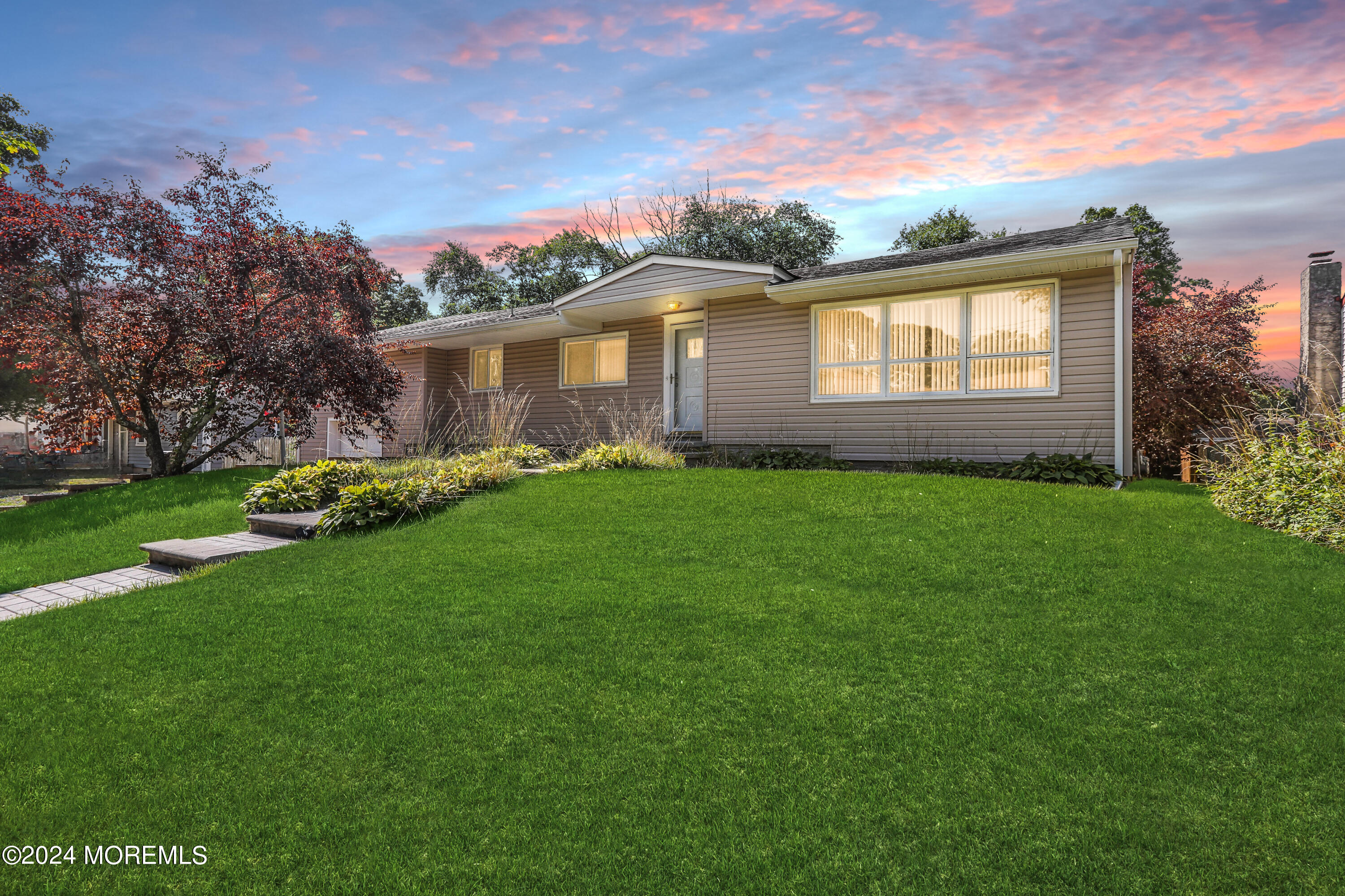 a front view of a house with a garden