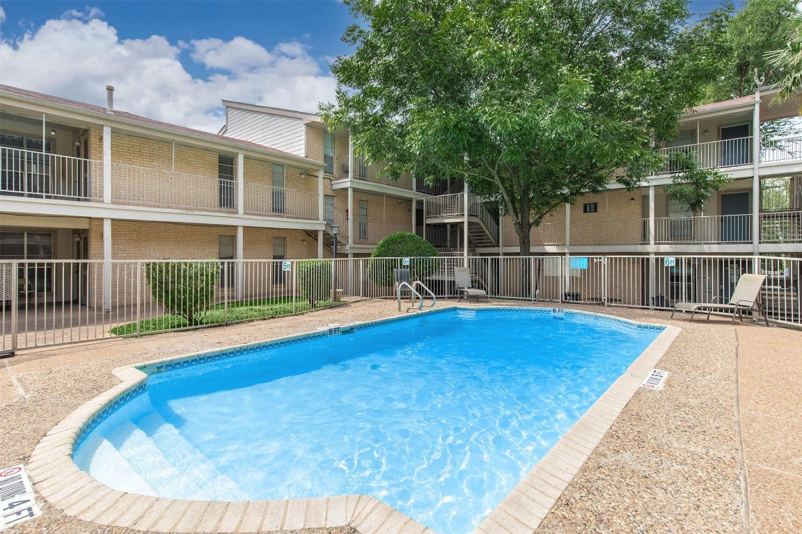 a view of a swimming pool with a lounge chair