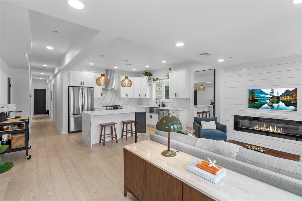 a living room with stainless steel appliances kitchen island granite countertop furniture and a kitchen view