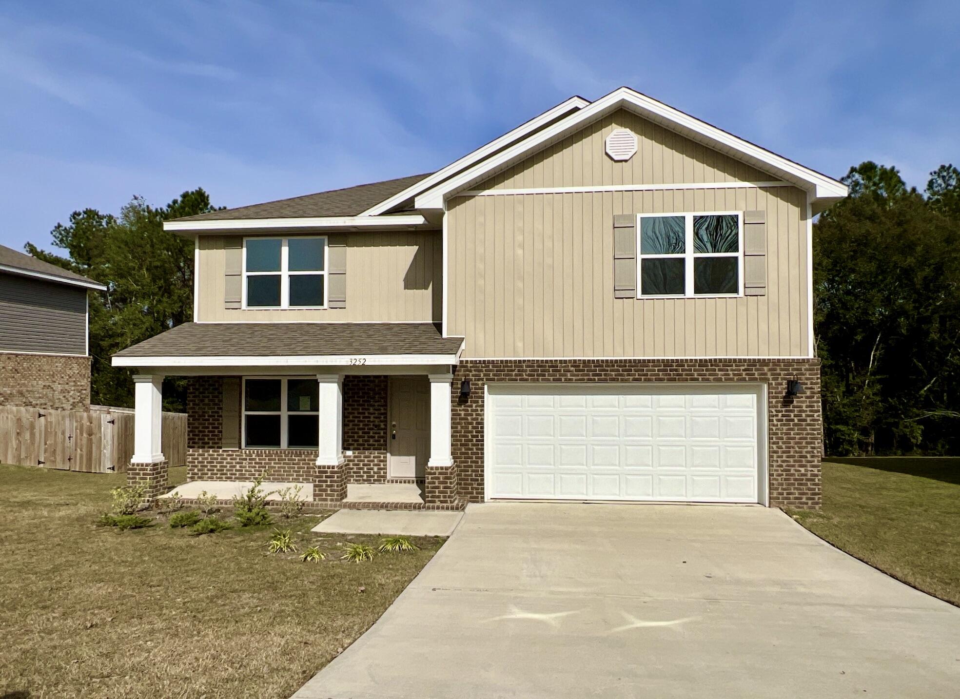 a front view of a house with a yard garage and outdoor seating