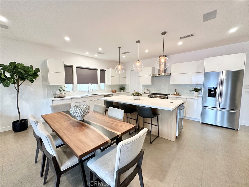 a kitchen with a table and chairs in it