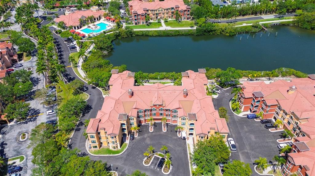 an aerial view of house with yard and lake view