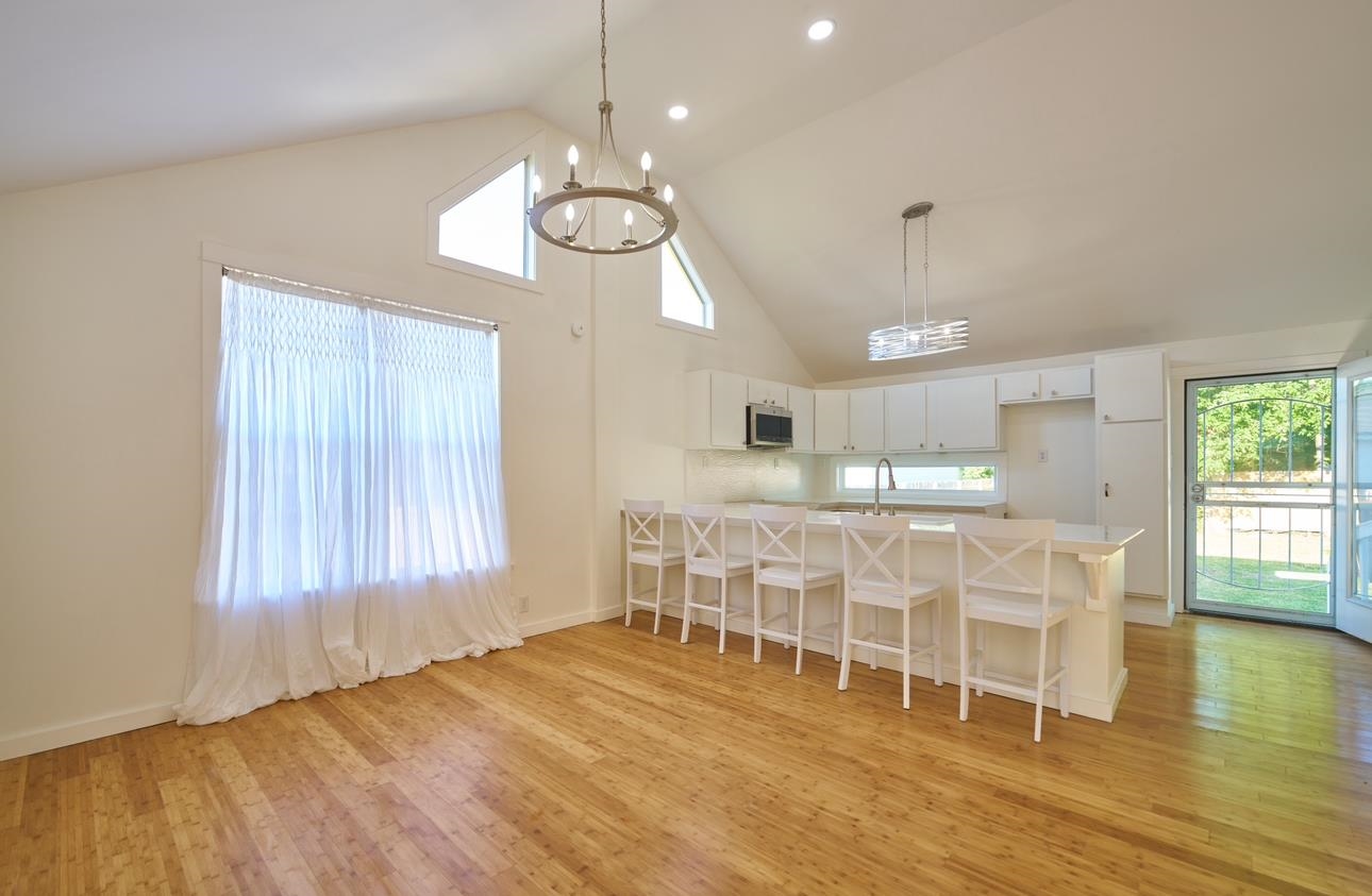 a view of a dining room with furniture wooden floor and chandelier