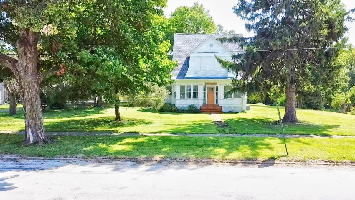 a view of a house with a yard patio and tree s